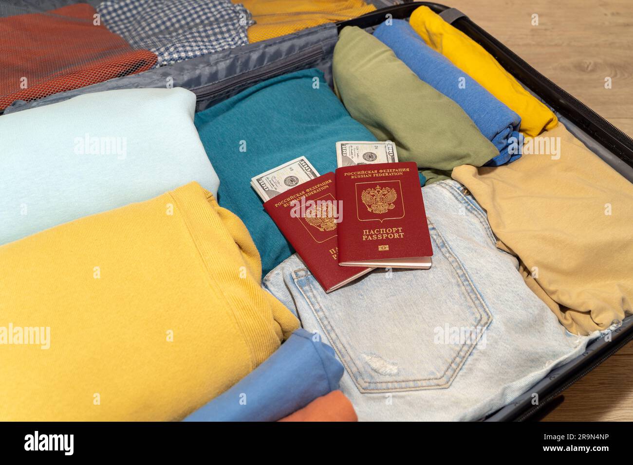 Open packed suitcase with Russian passports and dollars. Emigration in ...
