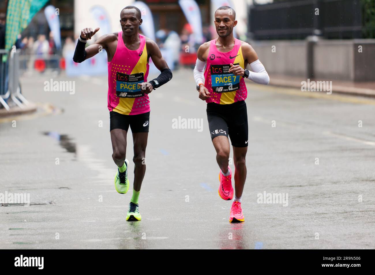 Pace Runners 5 and 7, smiling and waving, as they pass through Cabot