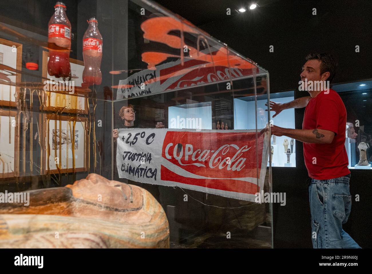 Climate activists stick their hands with glue to the showcases and pour liquids simulating blood and oil on the showcases of the Egyptian Museum of Ba Stock Photo