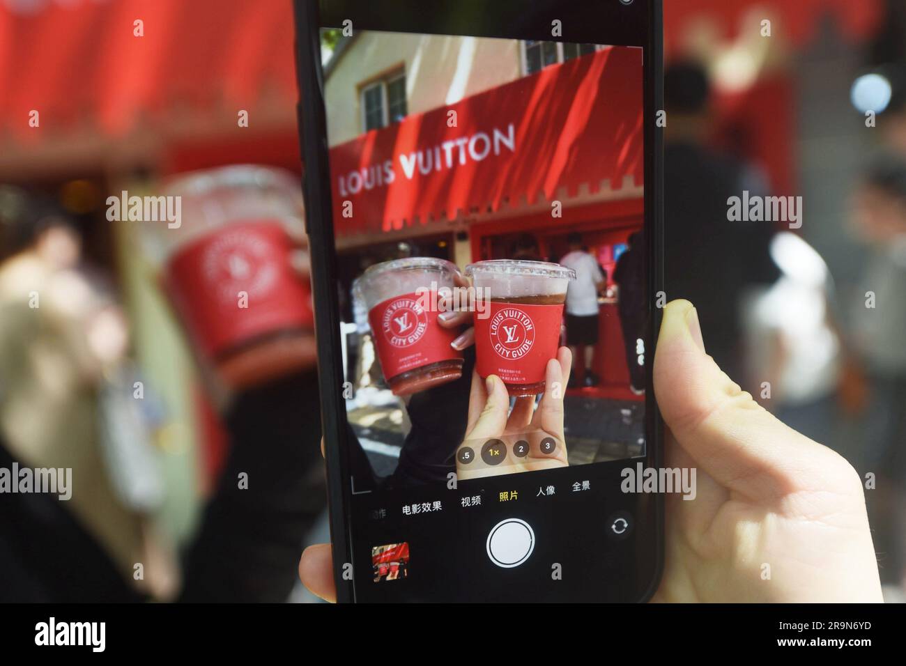 SHANGHAI, CHINA - JUNE 28, 2023 - People take photos of Louis Vuitton  coffee they just bought at the entrance of a Louis Vuitton cafe in  Shanghai, Chi Stock Photo - Alamy