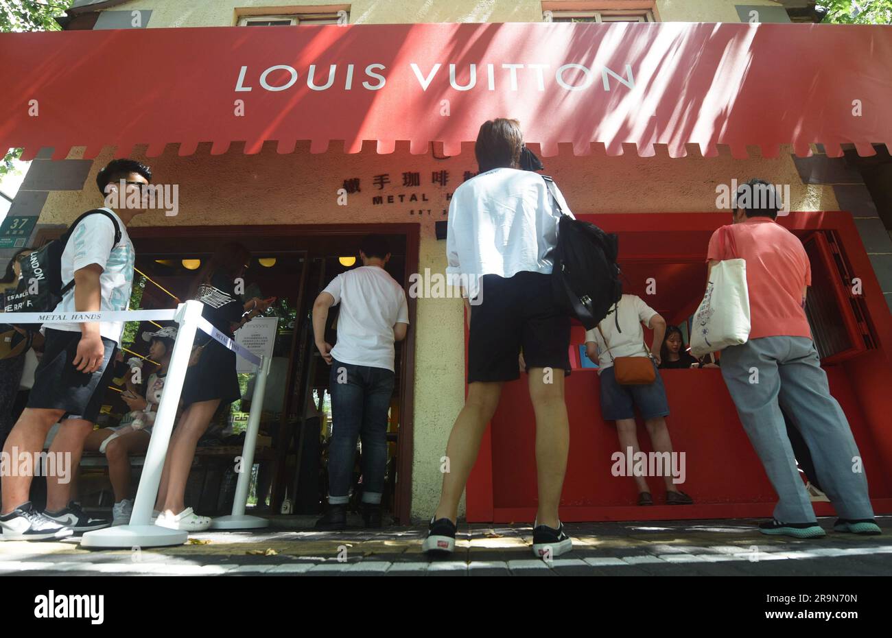SHANGHAI, CHINA - JUNE 28, 2023 - People line up to buy Louis Vuitton coffee  and canvas bags with Louis Vuitton LOGO at a Louis Vuitton coffee shop in  Stock Photo - Alamy