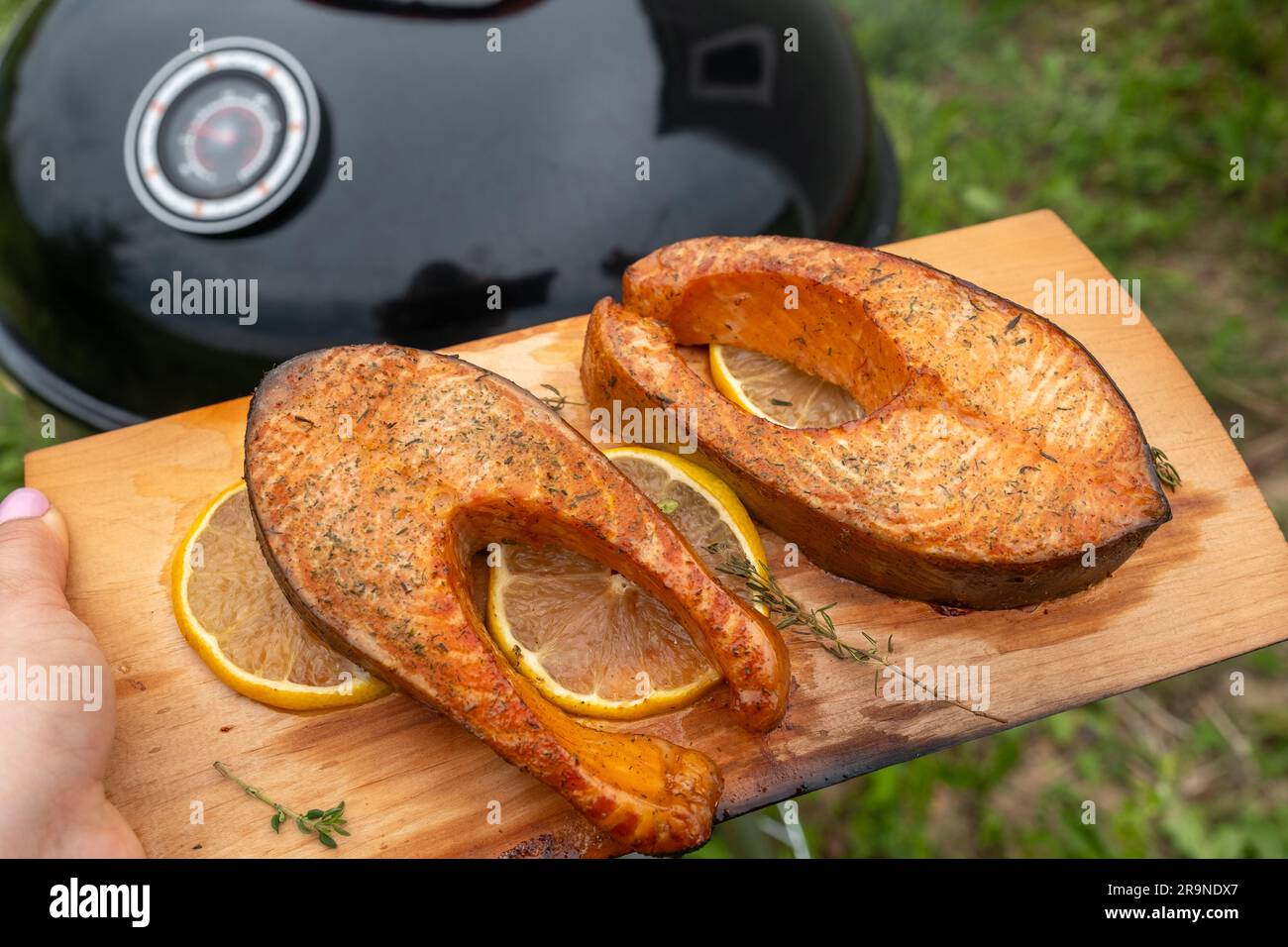 cedar plank salmon with lemon cooking on grill Stock Photo Alamy
