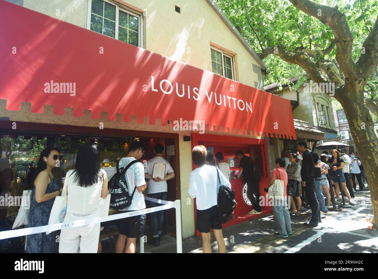 SHANGHAI, CHINA - JUNE 28, 2023 - People take photos of Louis Vuitton  coffee they just bought at the entrance of a Louis Vuitton cafe in  Shanghai, China, June 28, 2023. Recently