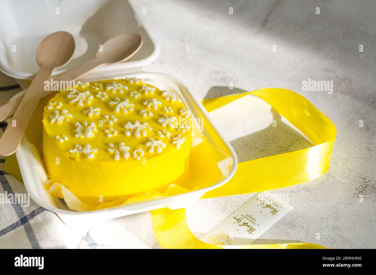 Trendy bento cake yellow color with cute decor on light background ...