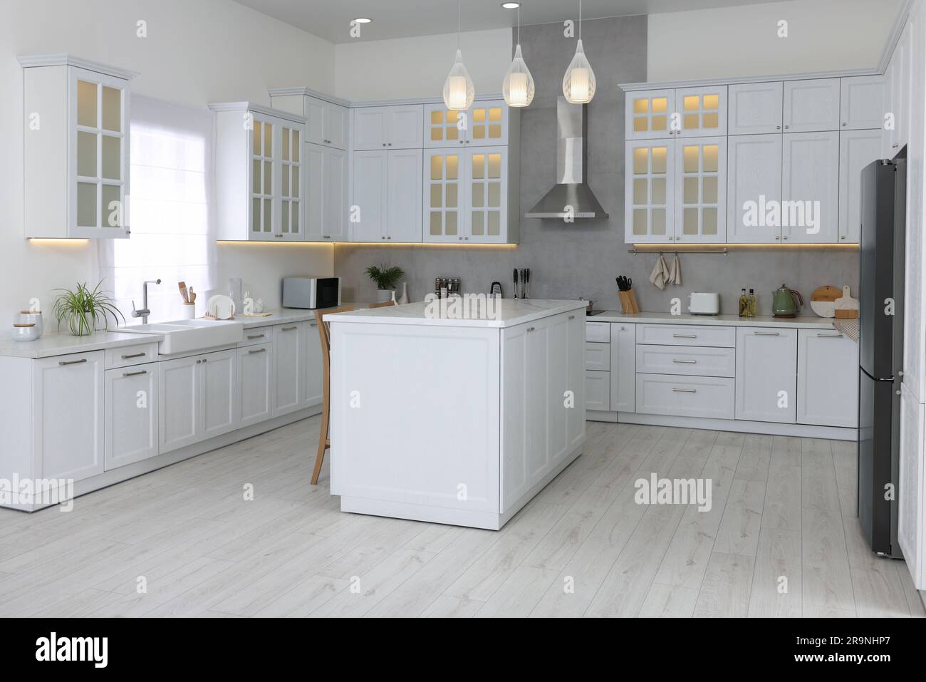 Stylish kitchen with modern furniture and different appliances ...