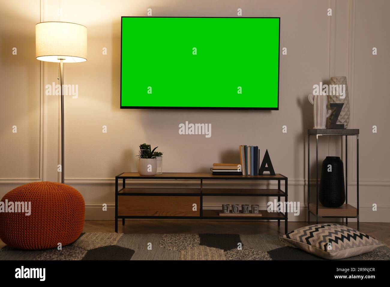 Chroma key compositing. TV with mockup green screen in room. Mockup for design Stock Photo