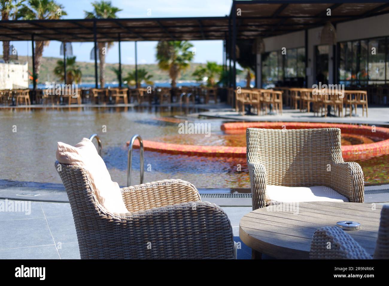 Wooden tables and chairs at poolside in a hotel Stock Photo Alamy
