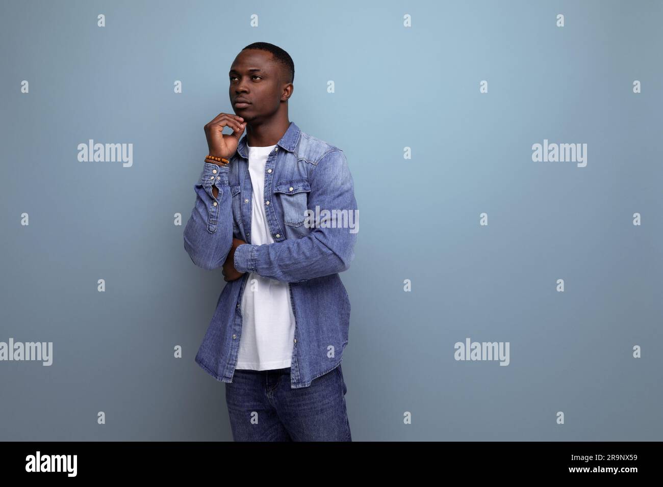 portrait of young smart inspired with dark skin american guy dressed  stylishly in casual clothes on blue background with copy space Stock Photo 