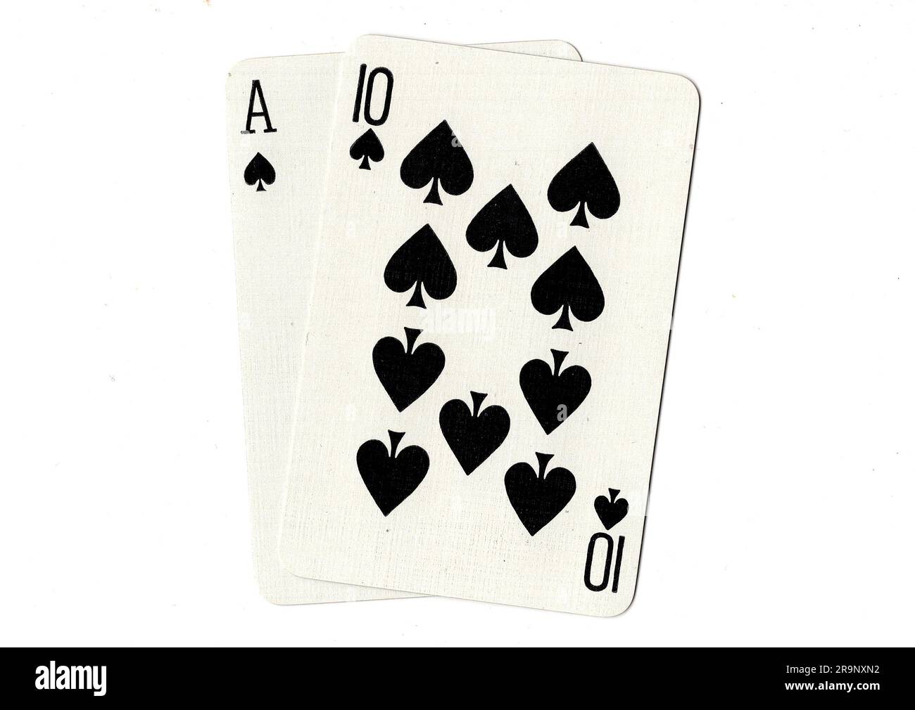 Vintage playing cards showing an ace of spades and a ten of spades on a
