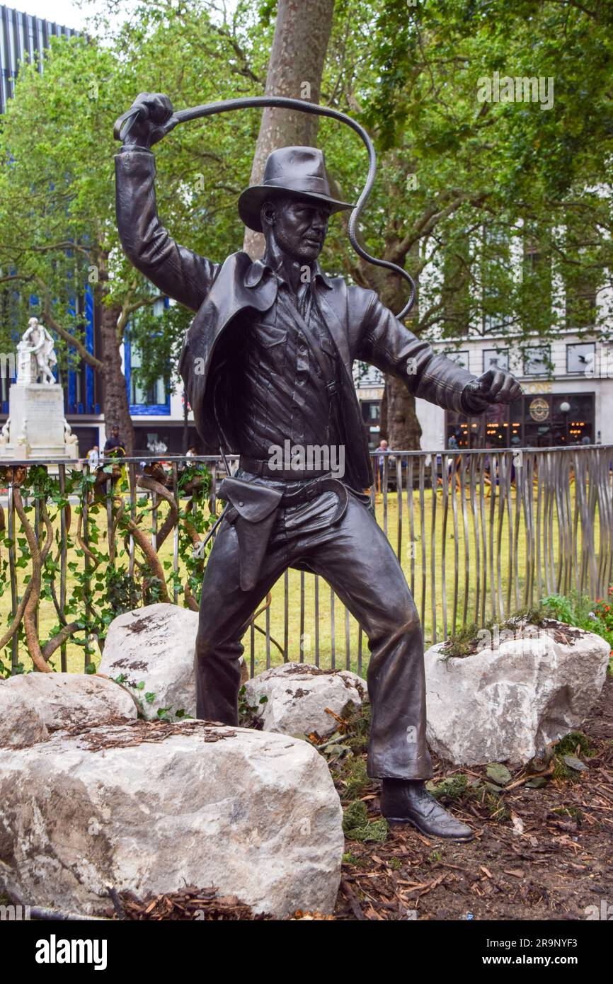 London, UK. 28th June 2023. A new sculpture of Indiana Jones has been unveiled in Leicester Square, part of the permanent statue trail 'Scenes In The Square' featuring famous film characters. The unveiling of the statue coincides with the UK opening of Indiana Jones and the Dial of Destiny. Credit: Vuk Valcic/Alamy Live News Stock Photo