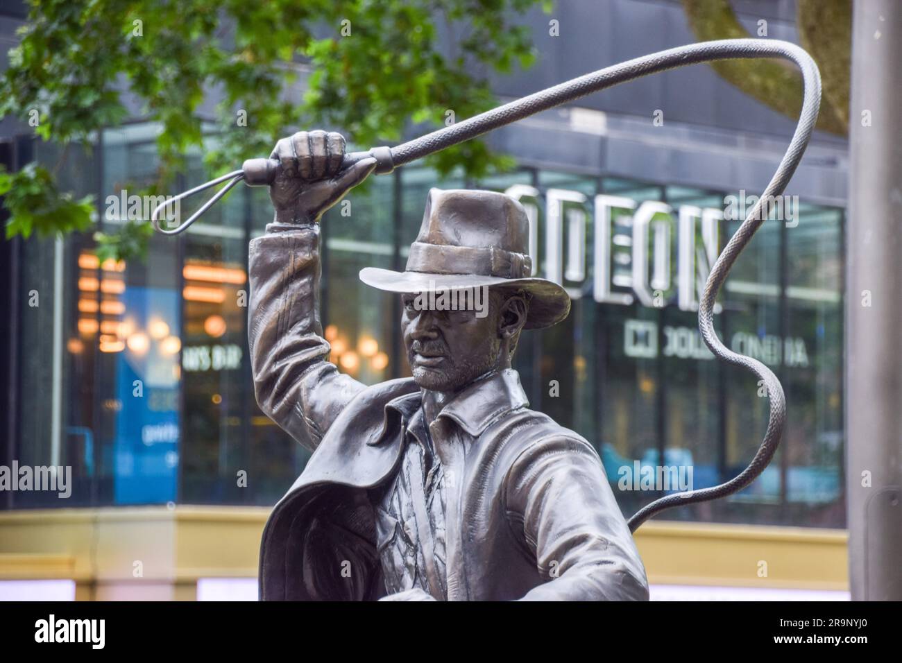 London, UK. 28th June 2023. A new sculpture of Indiana Jones has been unveiled in Leicester Square, part of the permanent statue trail 'Scenes In The Square' featuring famous film characters. The unveiling of the statue coincides with the UK opening of Indiana Jones and the Dial of Destiny. Credit: Vuk Valcic/Alamy Live News Stock Photo