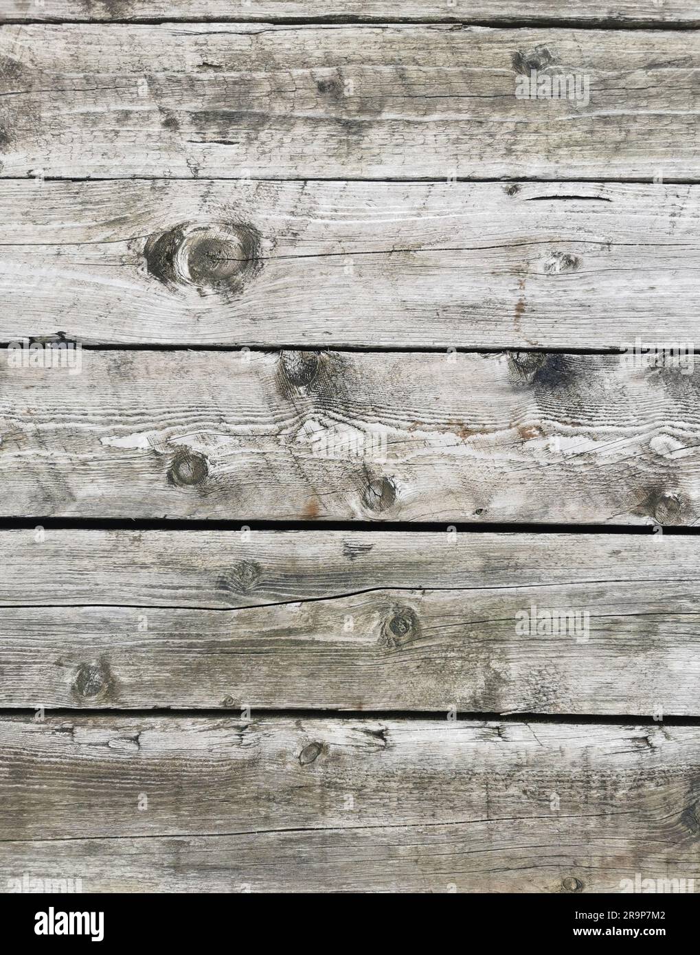 A wooden plank background, showing signs of wear and tear, with rusting