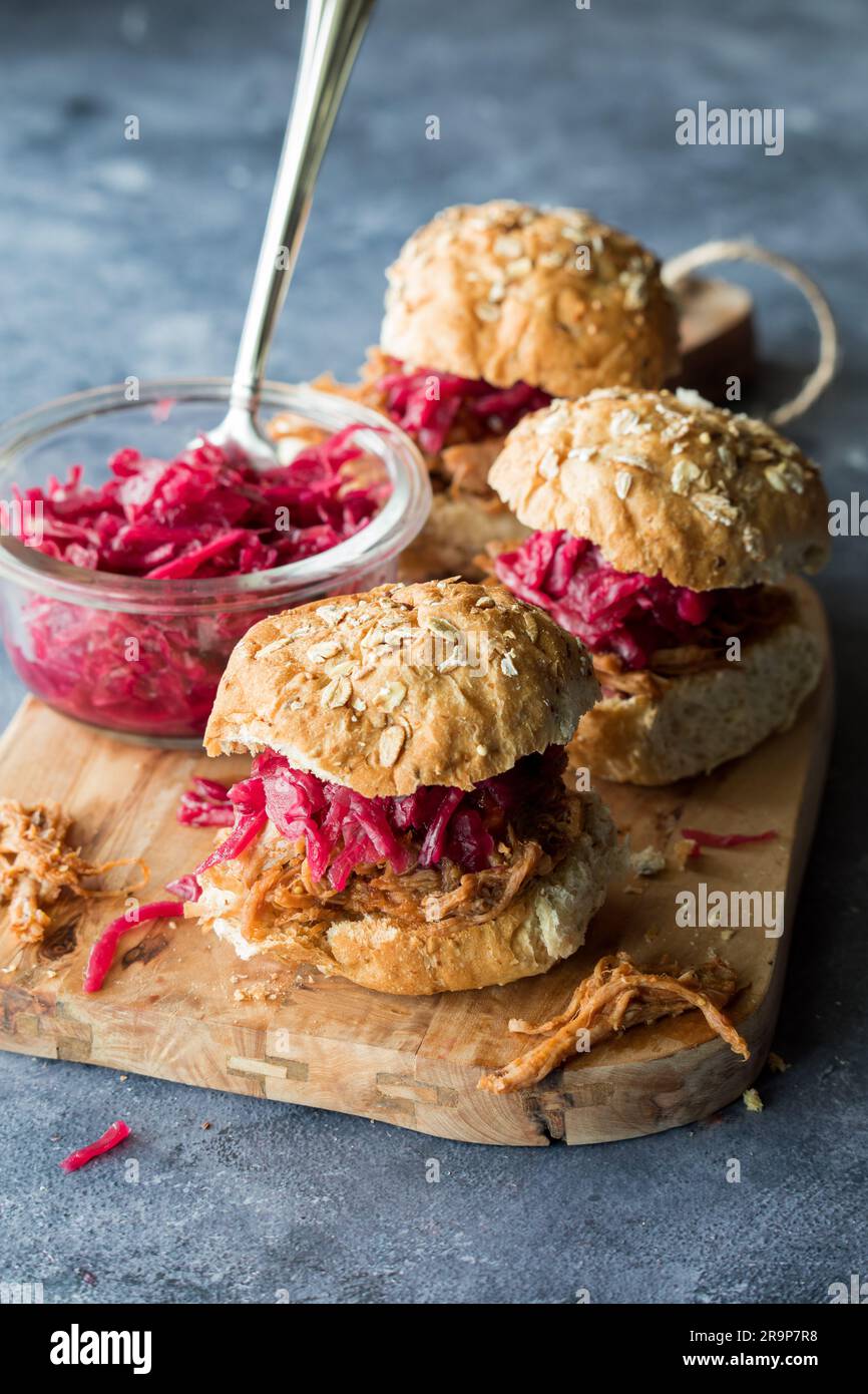 Pulled pork slider buns topped with pickled red cabbage and beet