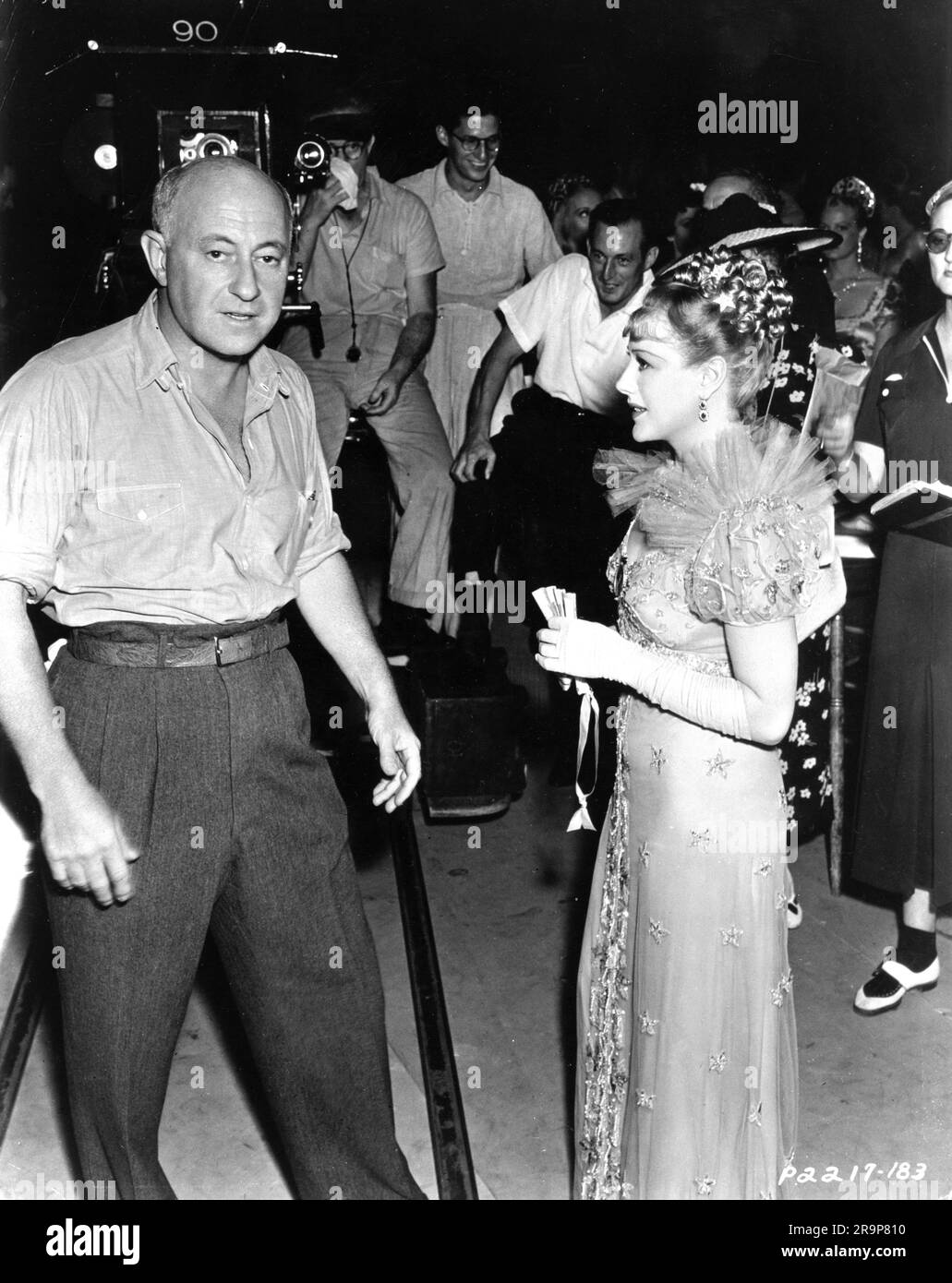 CECIL B. DeMILLE and Hungarian actress FRANCISKA GAAL on set candid with Movie Crew during filming of THE BUCCANEER 1938 director CECIL B. DeMILLE novel Lyle Saxon Paramount Pictures Stock Photo