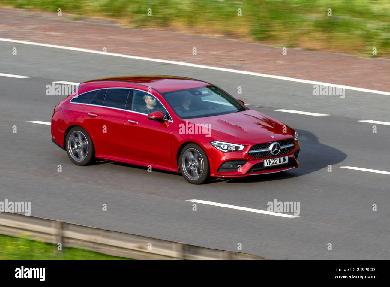2022 Red Mercedes-Benz Cla 180 Amg Line Premium Auto CLA180 7G-DCT Auto Start/Stop Red Car Estate Petrol 1332 cc travelling at speed on the M6 motorway in Greater Manchester, UK Stock Photo
