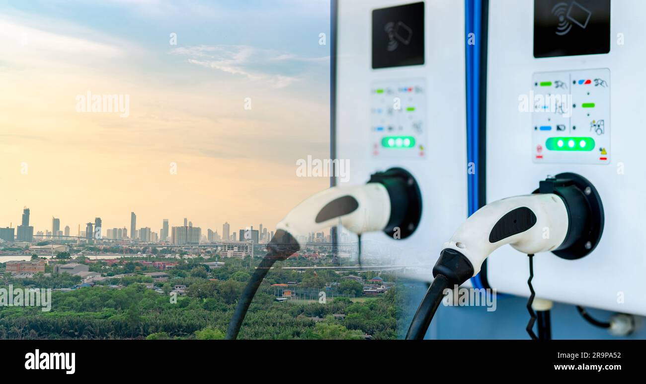 Electric vehicle charging station and sustainable city. EV charging infrastructure. Eco-friendly city. Green city transportation. Clean energy. Low Stock Photo