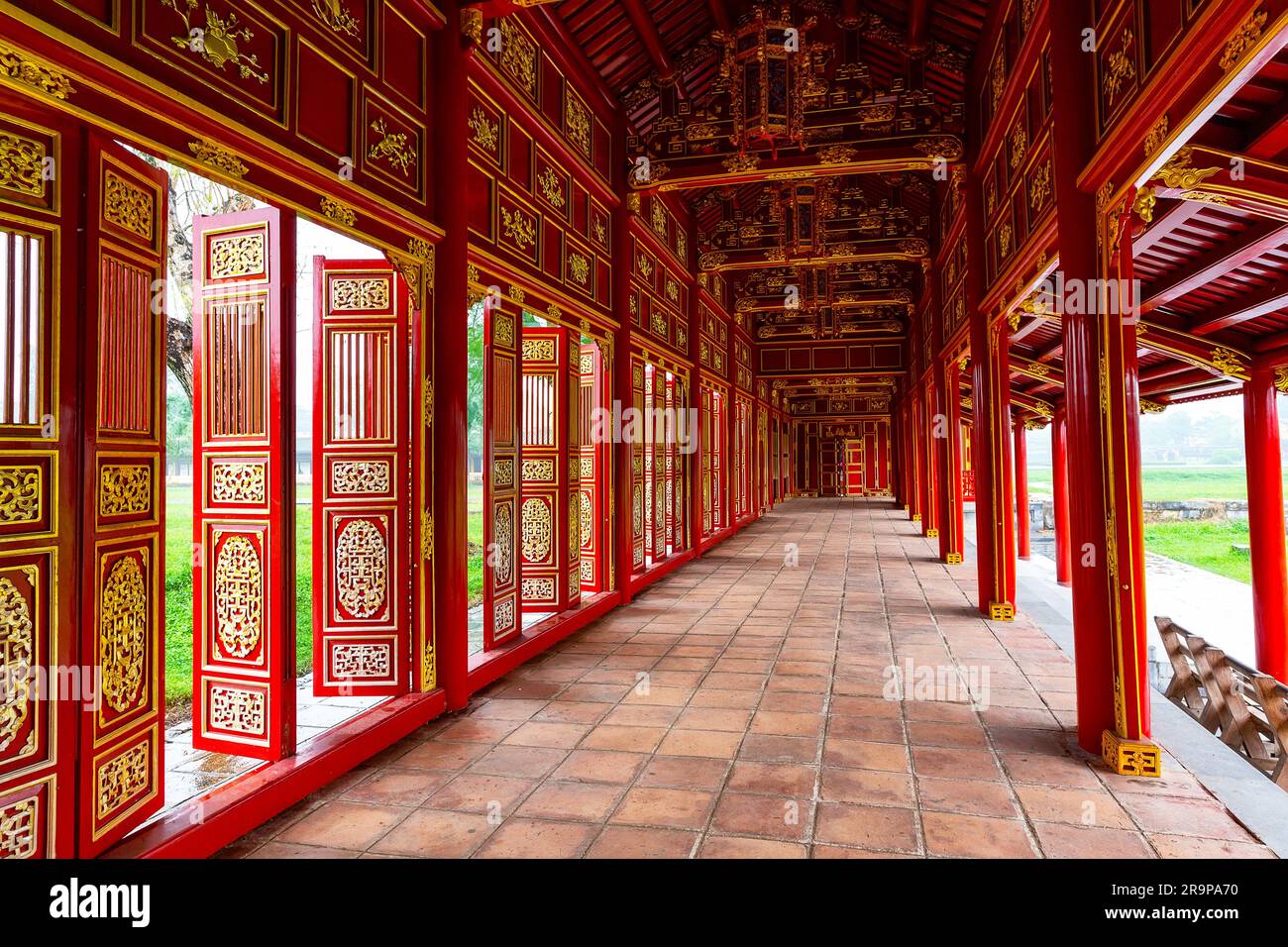 Corridor and red doors in the Forbidden Purple City of The Imperial City of Hue, Vietnam. Inside Forbidden Purple City, Hue, Vietnam. Stock Photo