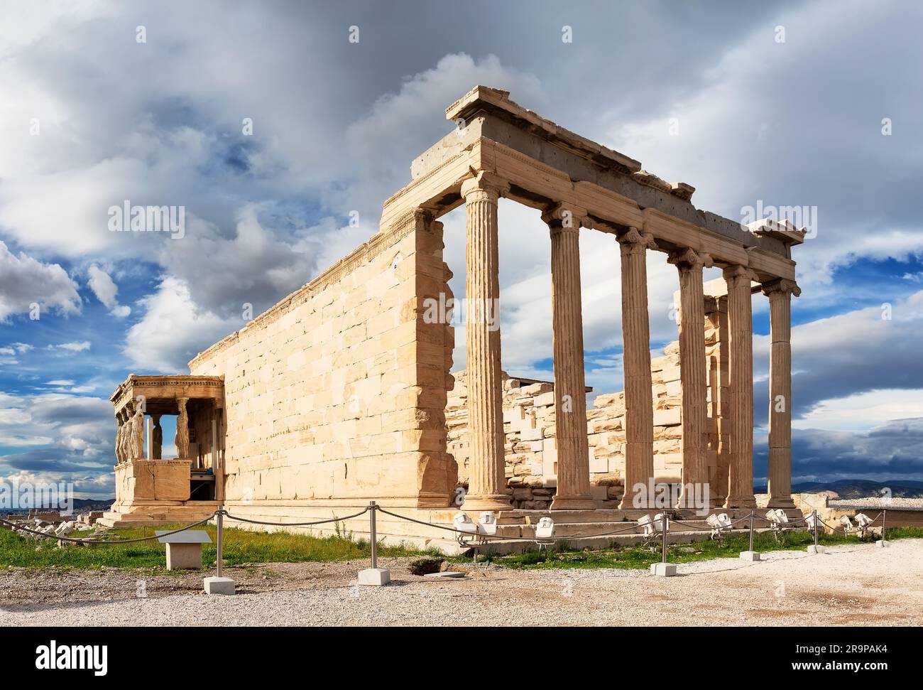 Ancient Erechtheion Greek temple on sunset with Porch of the Caryatids at Acropolis in Athens, Greece. Ruins of the temple of Erechtheion and temple o Stock Photo
