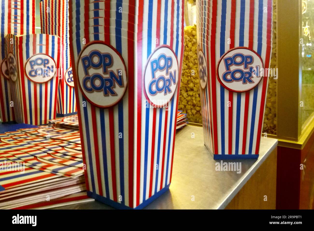 Close-up on a stack empty popcorn boxes before a popcorn maker. Stock Photo