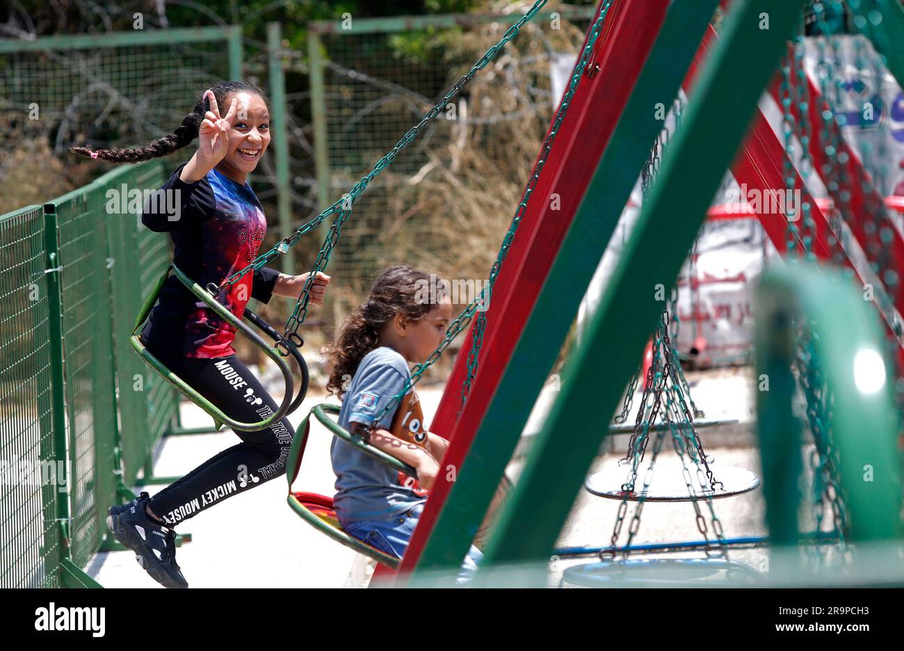 Beirut, Lebanon. 28th June, 2023. Children play on swings on the first day of Eid alAdha in