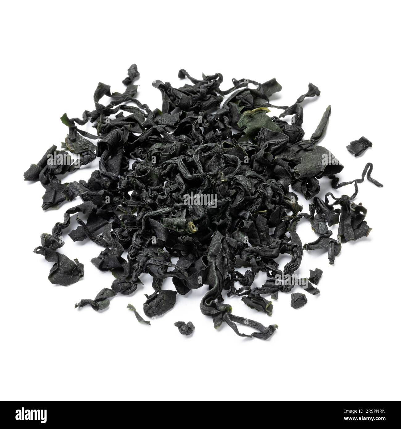 Heap of dried wakame seaweed isolated on white background close up Stock Photo