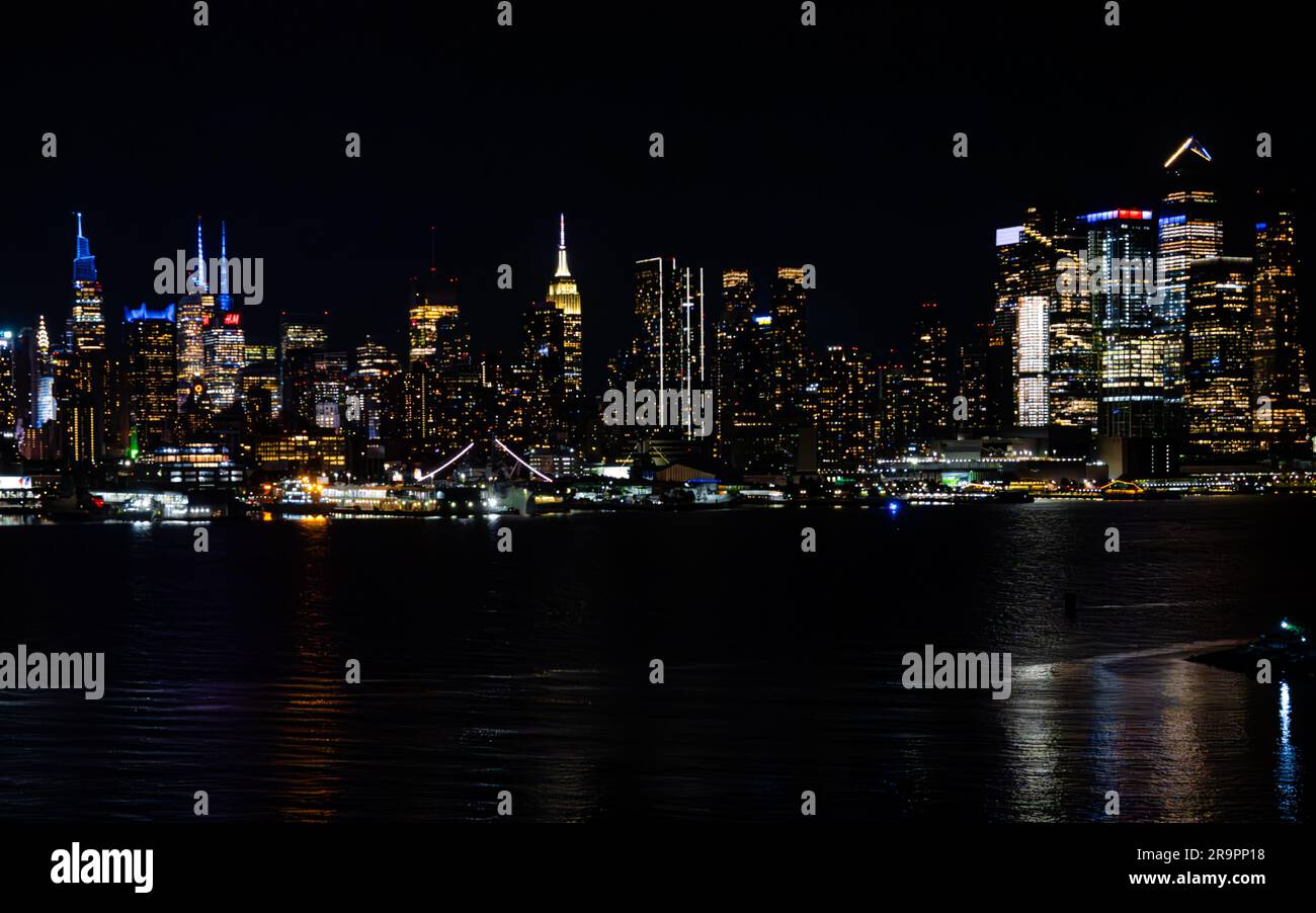 The night skyline of New York City, illuminated by vibrant lights Stock ...