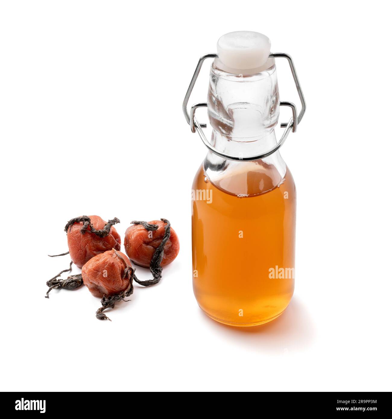 Glass bottle with homemade Japanese ume su, plum vinegar, close up and