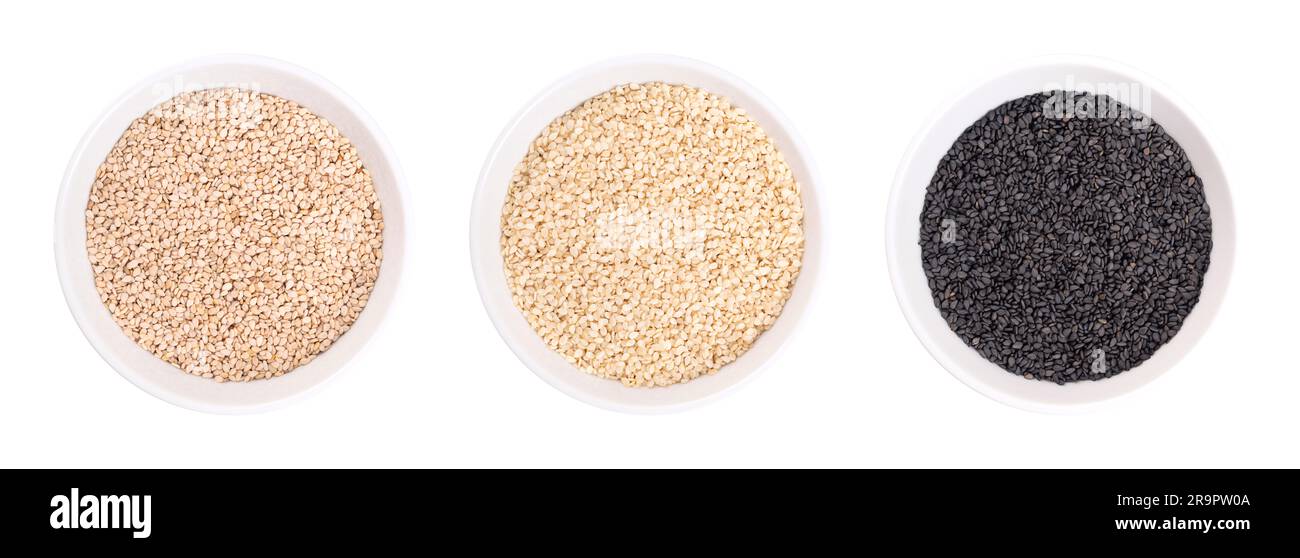 Black and white sesame seeds, benne in white bowls. Unhulled and hulled