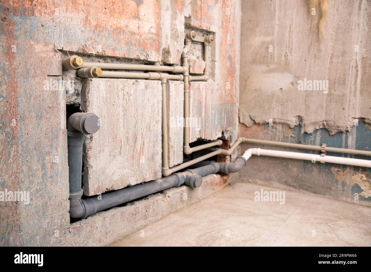 Supply of polypropylene water pipes in the wall and sewerage drain. Stock Photo