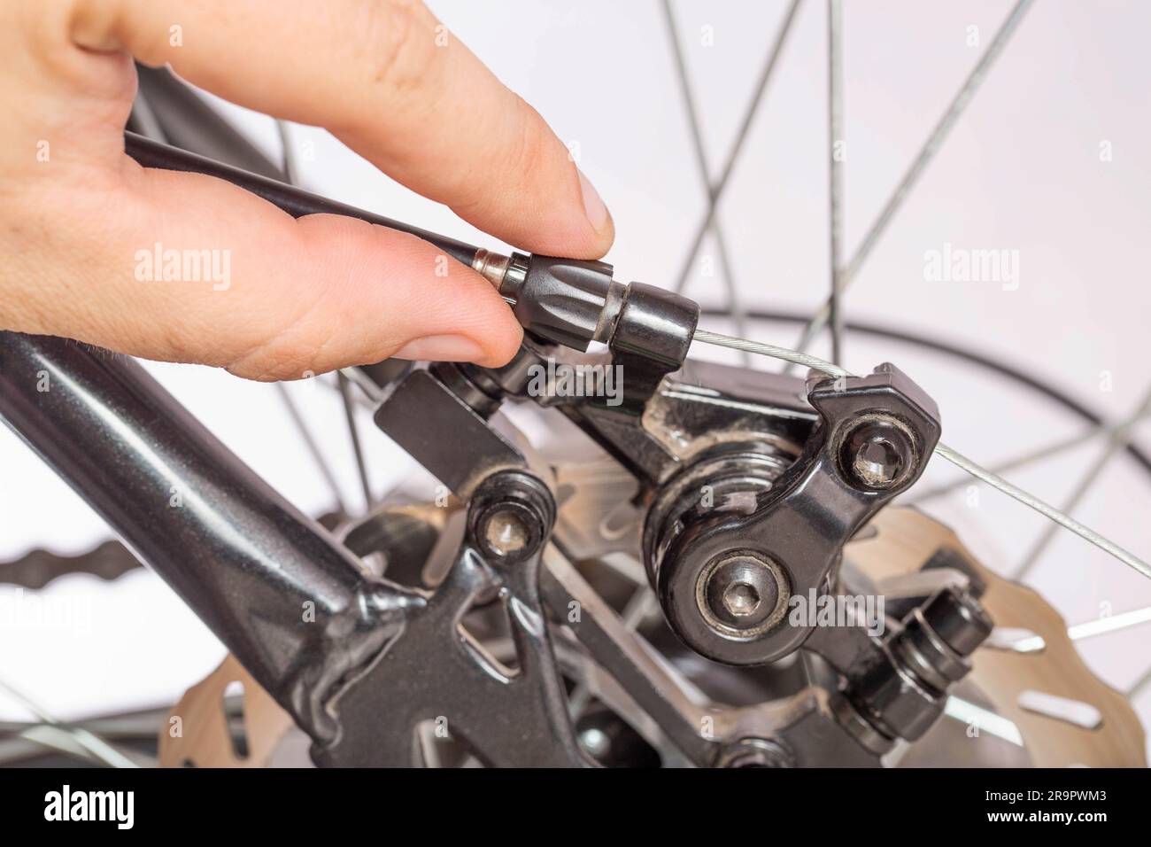 Adjusting the tension of the bicycle brake caliper cable. Brake setting. Copy space for text
