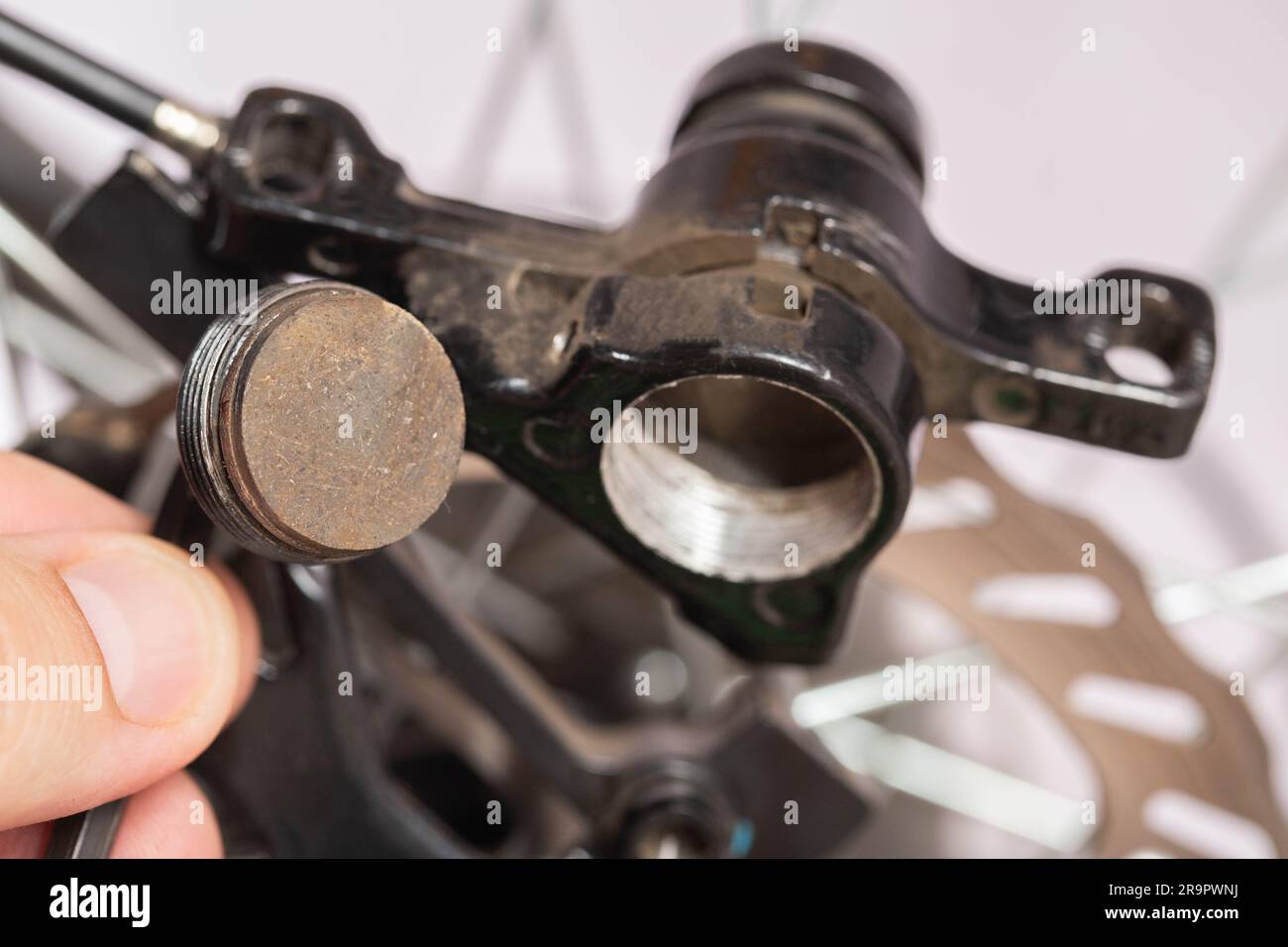 Brake pad in the hand of a bicycle repair and maintenance master