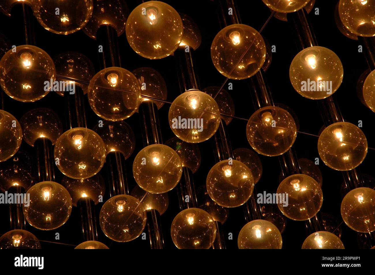 spherical light bulbs lit, evenly distributed on the ceiling Stock