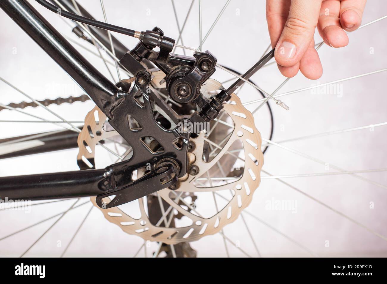 Unscrewing the bicycle brake caliper to change the brake pads and