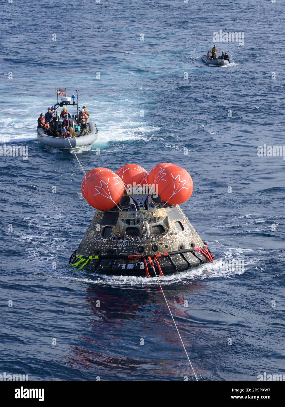 Orion Recovery. After splashing down at 12:40 p.m. EST on Dec. 11, 2022, U.S. Navy divers help recover the Orion Spacecraft for the Artemis I mission. NASA, the Navy and other Department of Defense partners worked together to secure the spacecraft inside the well deck of USS Portland approximately five hours after Orion splashed down in the Pacific Ocean off the coast of California. Stock Photo