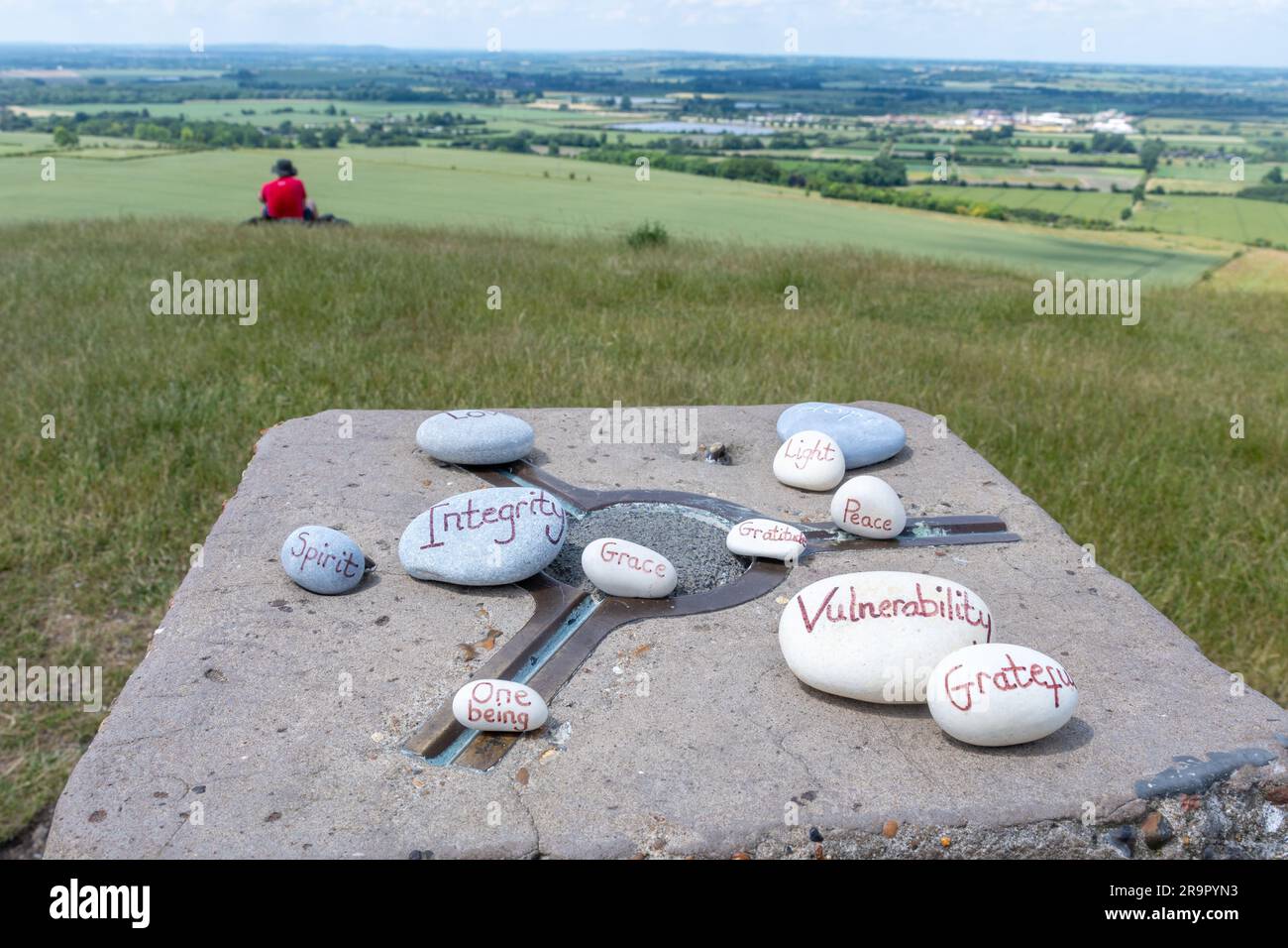 The summit of Ivinghoe Beacon in the Chilterns Area of Outstanding Natural Beauty, Buckinghamshire, England, UK, with painted stones on the trig point Stock Photo