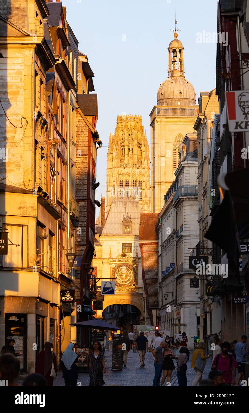 Great Clock, Rouen at sunset; 14th century clock with its bell tower to the right and Rouen Cathedral tower behind; street scene Rouen Normandy France Stock Photo
