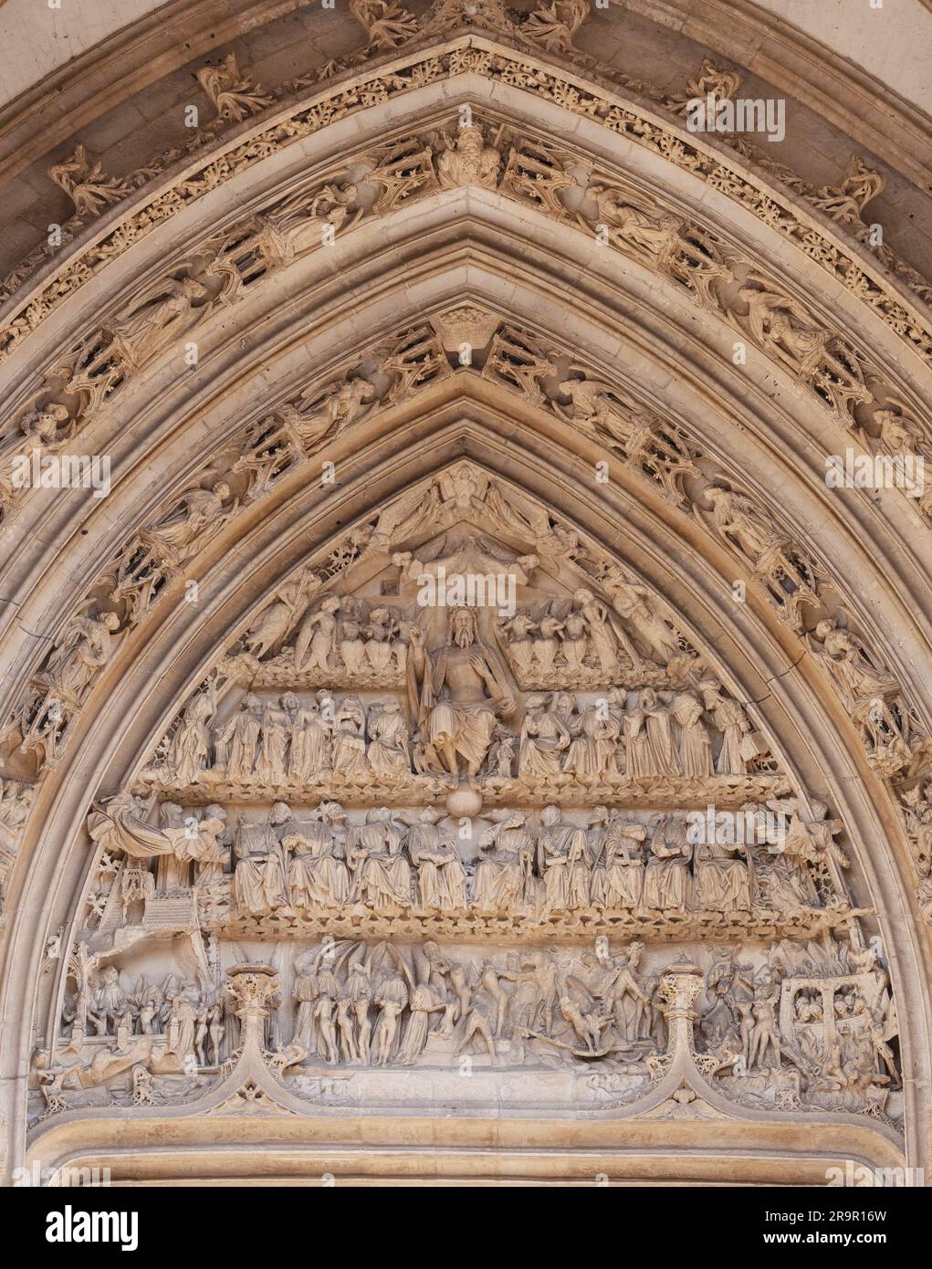 Gothic stone sculpture in the arch above the doors to Saint Maclou Church Rouen France showing Jesus Christ and people heading to heaven or hell. Stock Photo