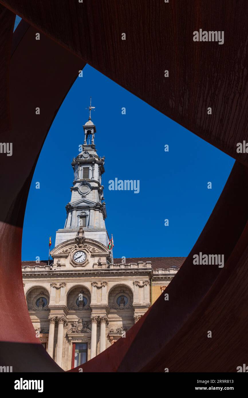 Spain, Basque Country, Bilbao, City Hall in the Baroque style dating from 1892 viewed through a sculpture by Jorge Oteiza in front of the building. Stock Photo