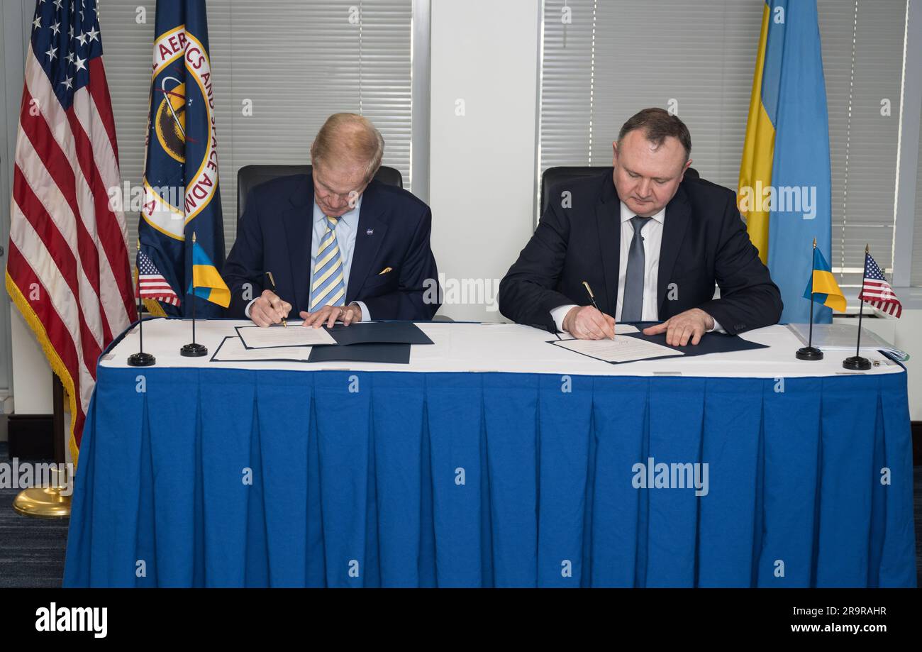 NASA Admin Signs Joint Statement with Space Agency of Ukraine . NASA Administrator Bill Nelson, left, and Deputy Chairman of the State Space Agency of Ukraine, Volodymyr Mikheiev, sign a joint statement on civil space cooperation between NASA and the State Space Agency of Ukraine, Friday April 21, 2023 at the Mary W. Jackson NASA Headquarters building in Washington DC. Stock Photo