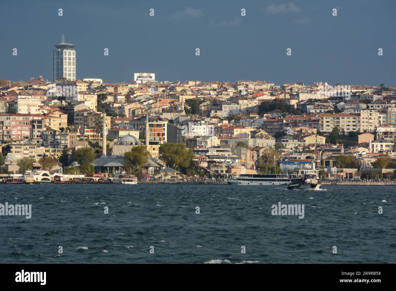 Looking across the Strait of Bosphorus from Beyoglu on the European side to Uskudar on the Asian side of Istanbul, Turkiye / Turkey. Stock Photo