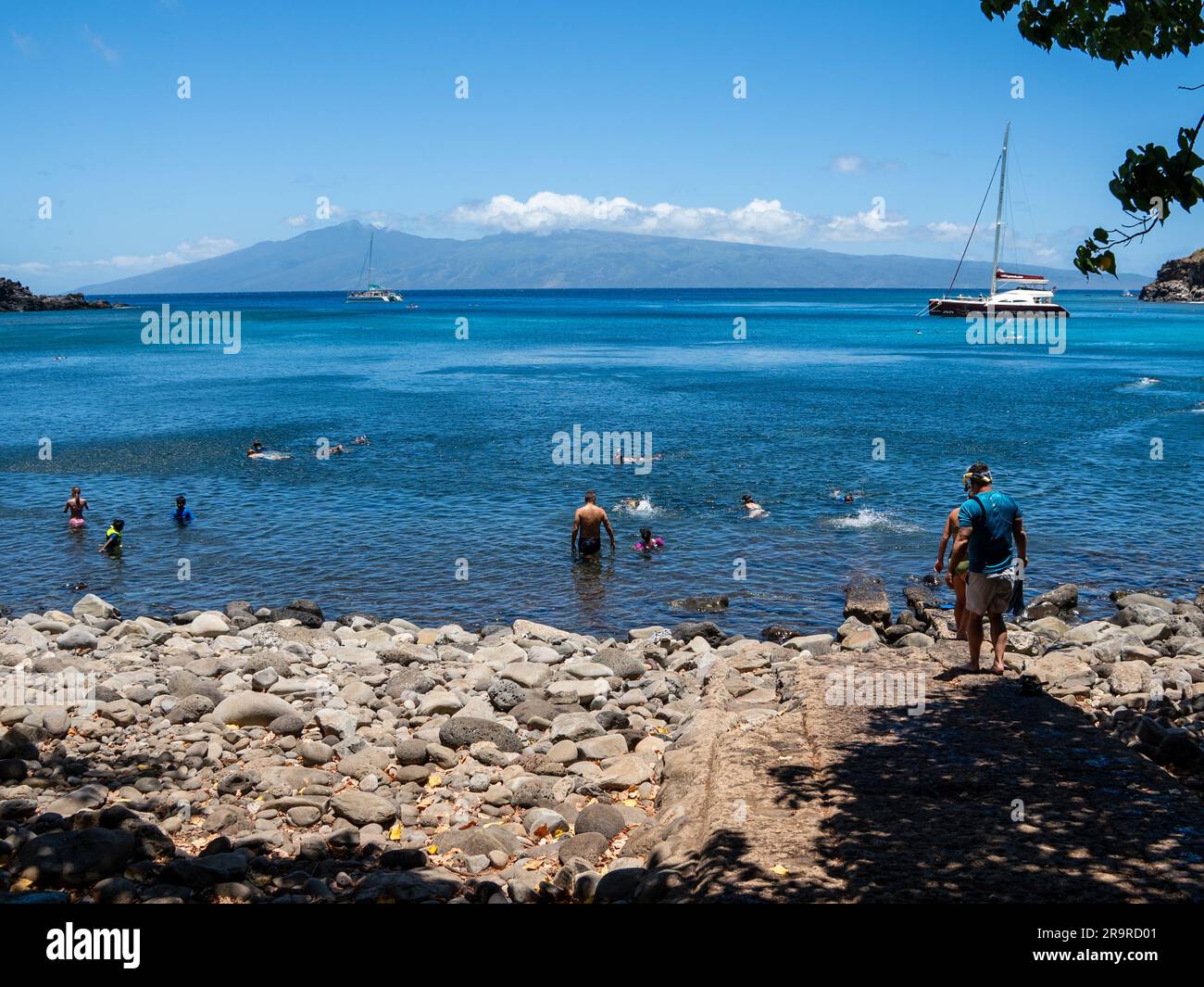 Boats are anchored in a shallow cove that is perfect for snorkeling Stock Photo