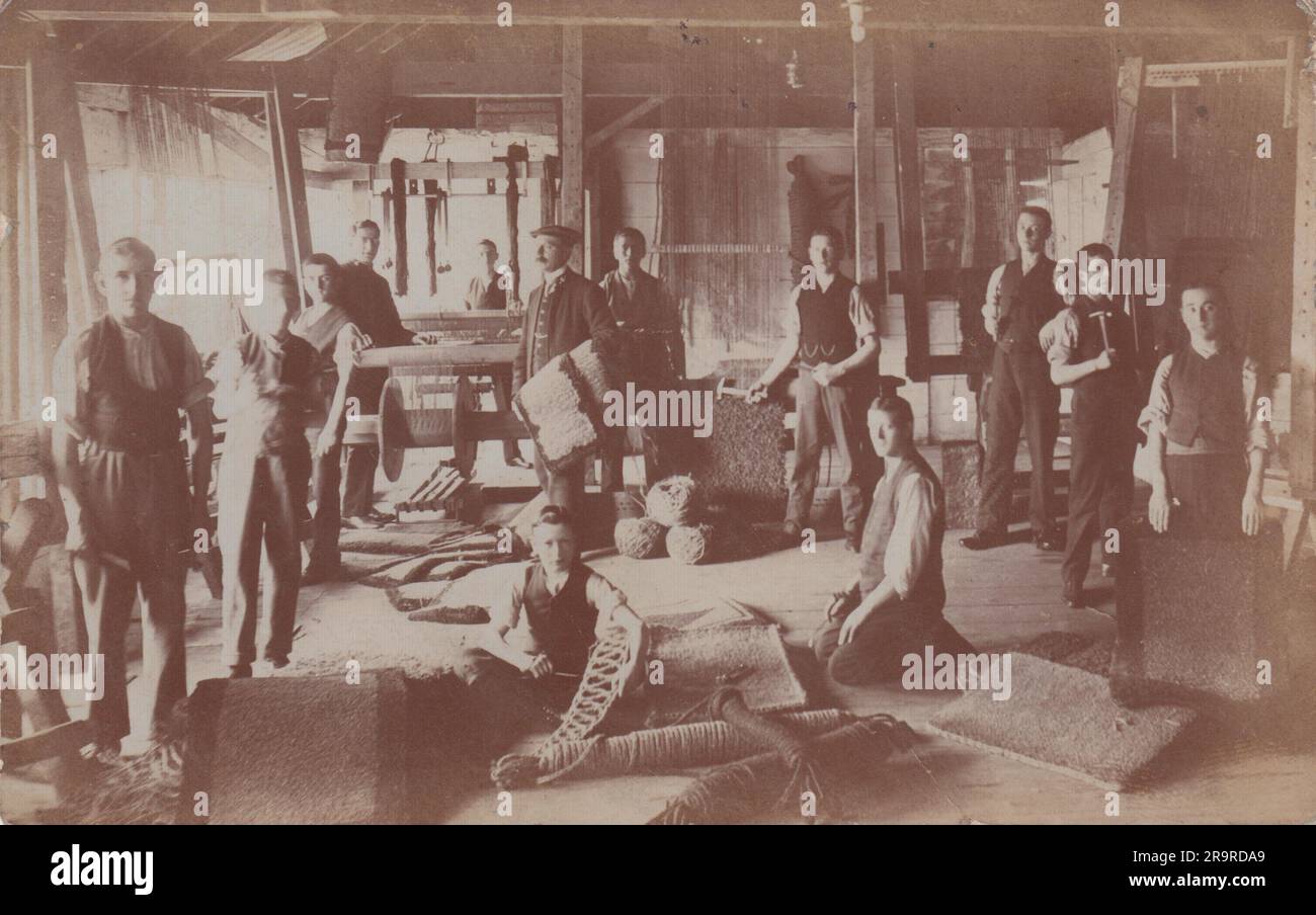 Early 20th century photograph of a group of men and boys in a rug ...