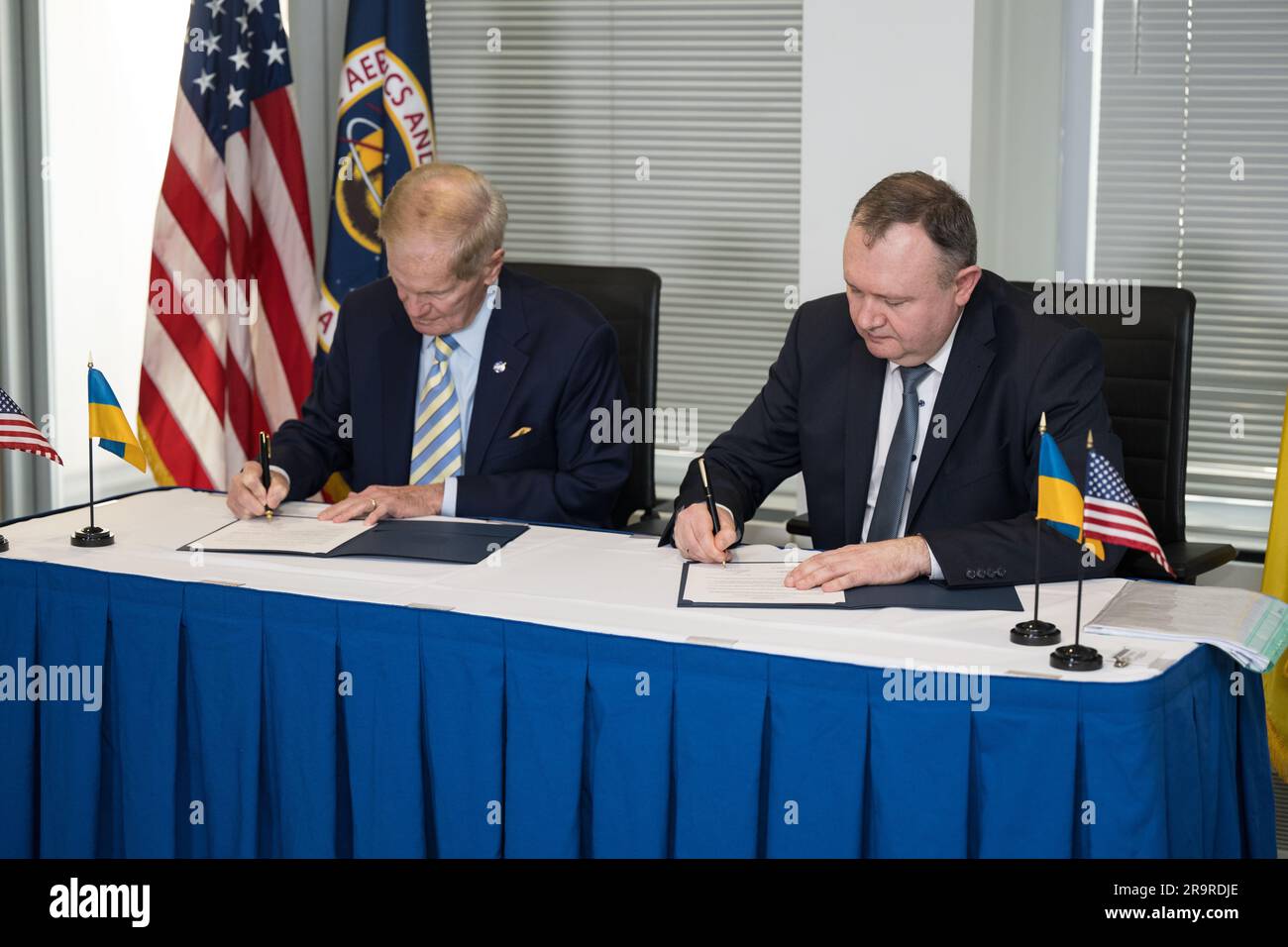 NASA Admin Signs Joint Statement with Space Agency of Ukraine . NASA Administrator Bill Nelson, left, and Deputy Chairman of the State Space Agency of Ukraine, Volodymyr Mikheiev, sign a joint statement on civil space cooperation between NASA and the State Space Agency of Ukraine, Friday April 21, 2023 at the Mary W. Jackson NASA Headquarters building in Washington DC. Stock Photo