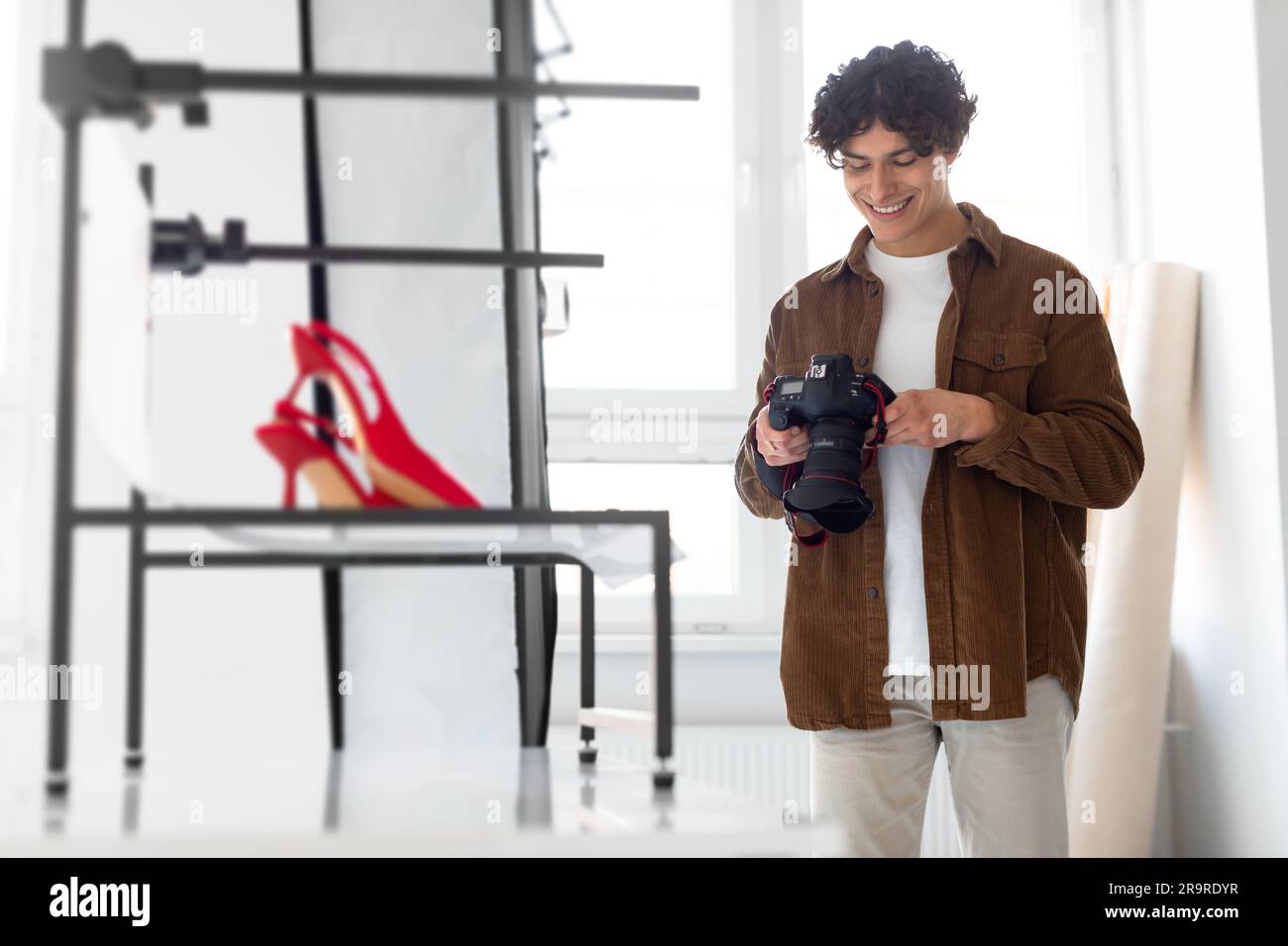 Happy photographer man checking the pictures