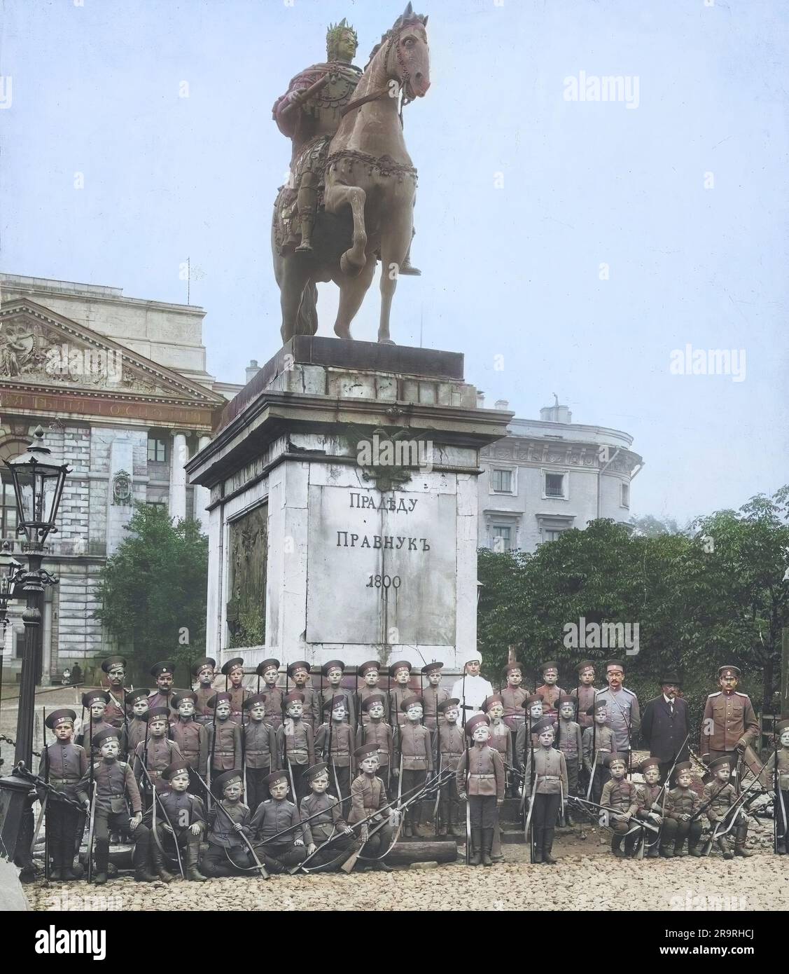 Approximately 1913 in Russia, group of young military cadets posing for a class photo beneath statue of Peter I in Stock Photo