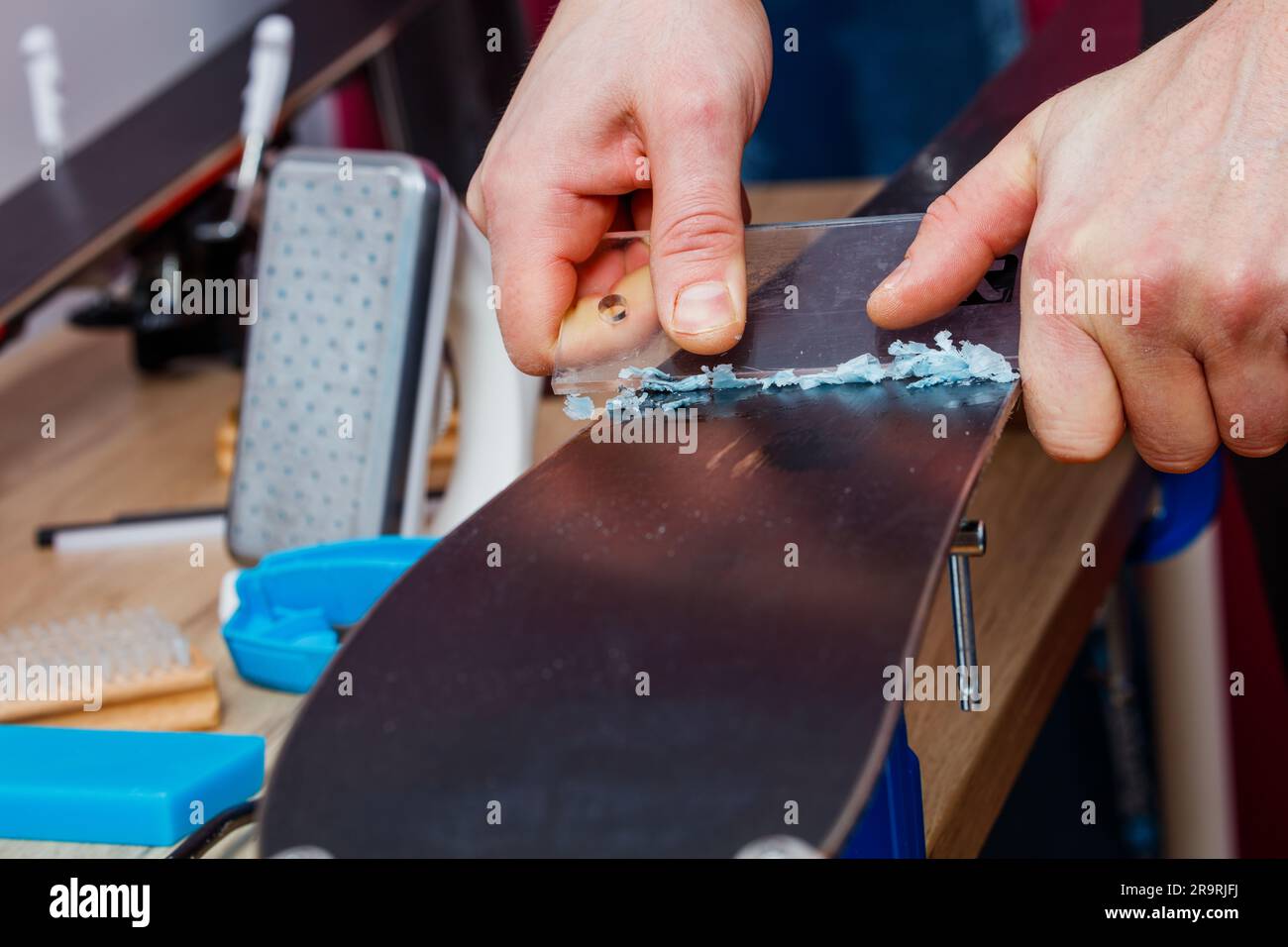 Hand scrape off wax from ski base before polishing Stock Photo Alamy