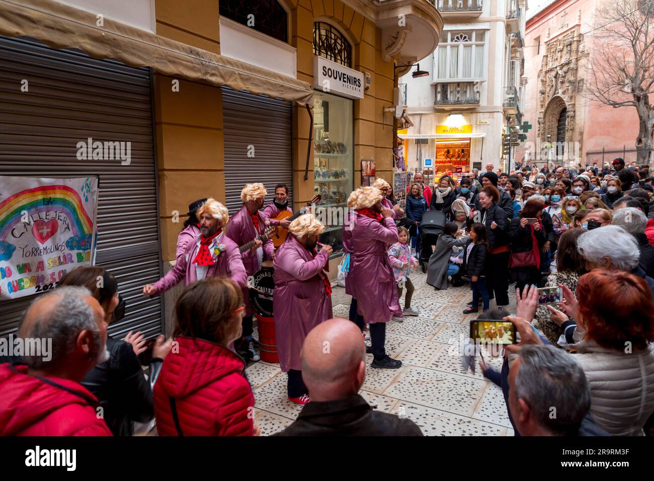Malaga, Spain - FEB 27, 2022: People celebrating the Malaga Carnival with costumes, confettis, music, dance, marches and plays for kids in Malaga Stock Photo