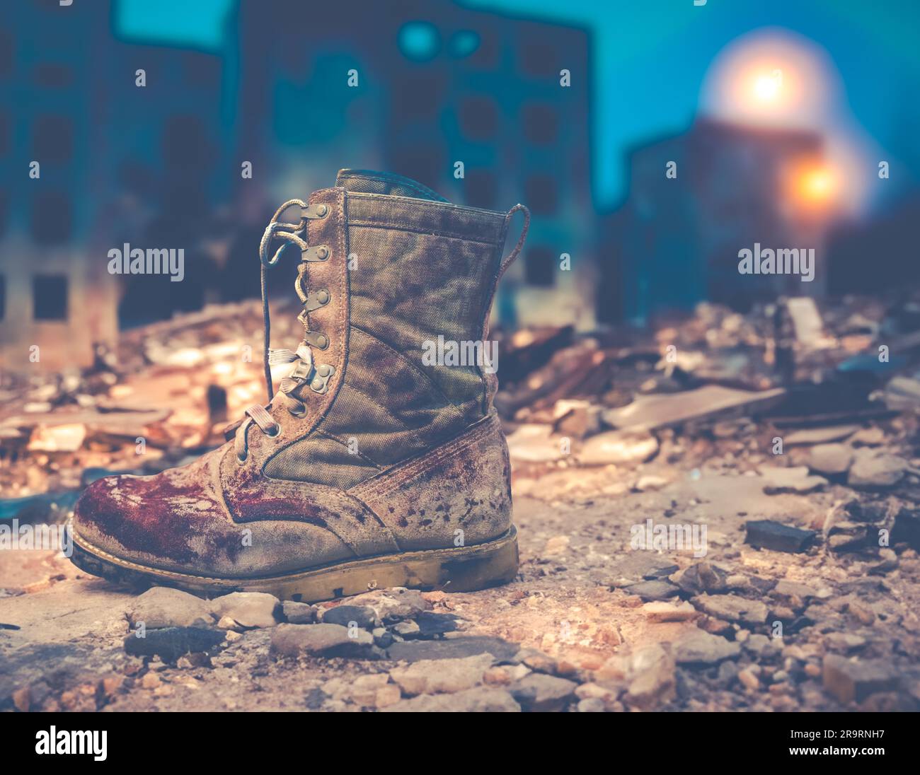 Dirty And Bloody Army Boot In A Ruined War Zone City At Night Stock Photo