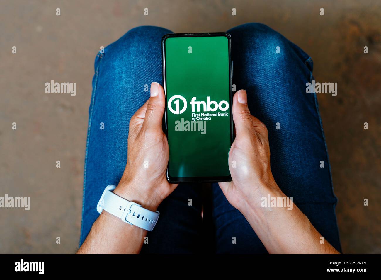 In this photo illustration, the First National Bank de Omaha (FNBO) logo is displayed on a smartphone mobile Stock Photo