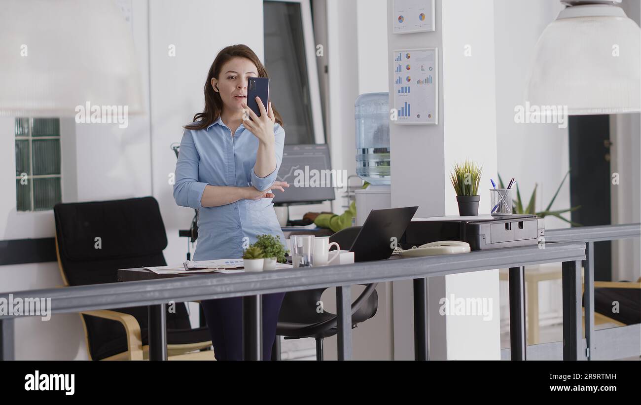 Agency employee using videocall meeting on smartphone, talking to ...